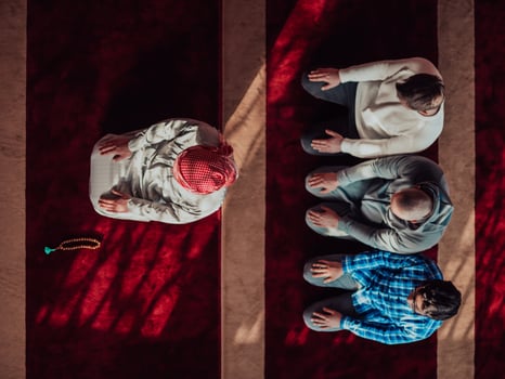 A group of Muslims in a modern mosque praying the Muslim prayer namaz, during the holy month of Ramadan photo