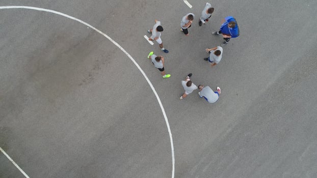 top view drone flying above amateur soccer game match. Countryside authentic tournament. photo