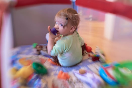 cute  little  baby playing in mobile  bed photo