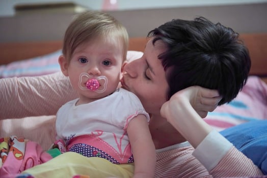 mother is playing with baby at home photo