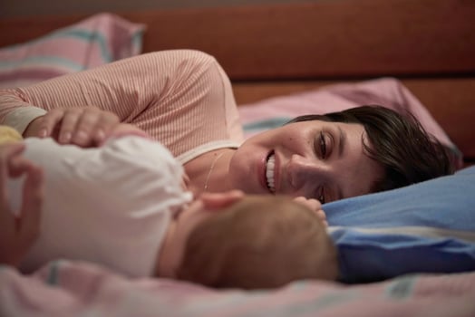mother is playing with baby at home photo