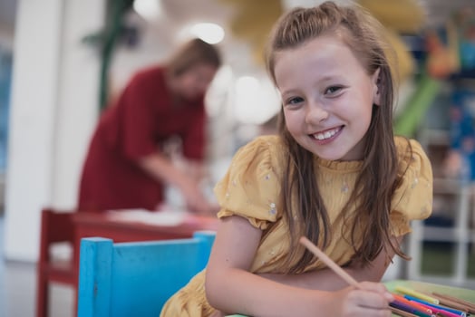 Creative kids sitting in a preschool institution, draw and have fun while they get an education photo