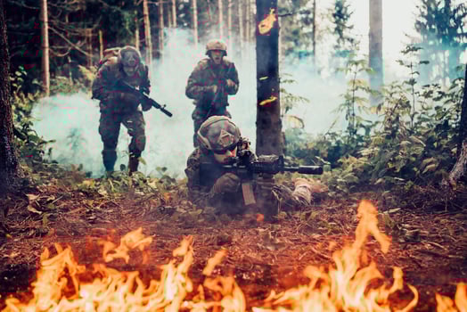 Modern warfare soldiers surrounded by fire fight in dense and dangerous forest areas photo