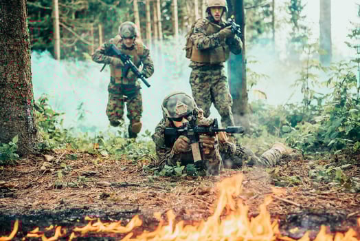 Modern warfare soldiers surrounded by fire fight in dense and dangerous forest areas photo