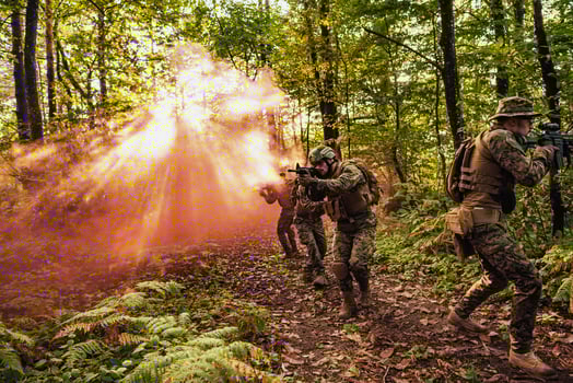 A group of modern warfare soldiers is fighting a war in dangerous remote forest areas. A group of soldiers is fighting on the enemy line with modern weapons. The concept of warfare and military conflicts photo