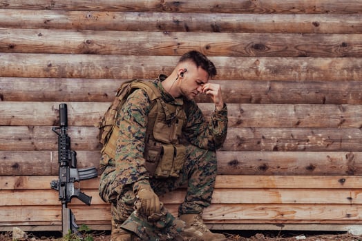 Upset soldier has psychological problems holding his head photo