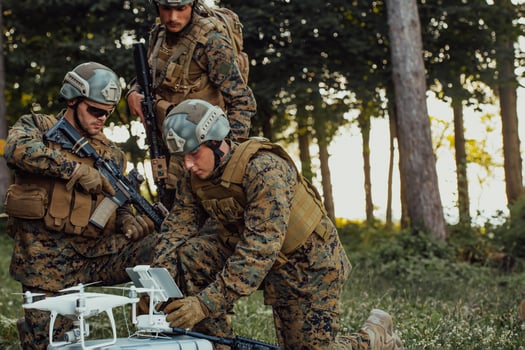 Modern Warfare Soldiers Squad are Using Drone for Scouting and Surveillance During Military Operation in the Forest. photo