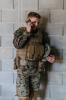 Soldier using smartphone and calling home family and friends photo