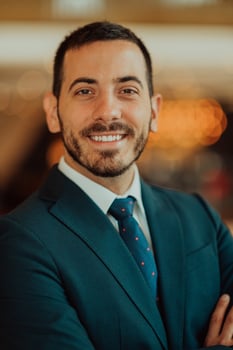 Portrait of a businessman in a suit with his arms crossed in a modern office building photo