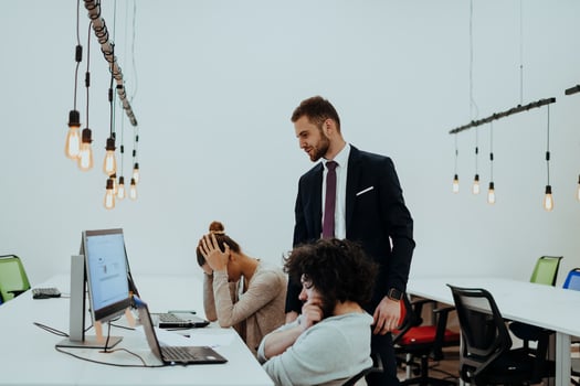 Group of multi-ethnic colleagues working on desktop computers, laptop and sharing their ideas in a modern office space.Young influencers work on online marketing projects. photo