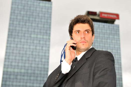 Photo of happy winner businessman  talking on mobile phone