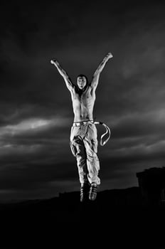 young man dancing and jumping  on top of the building photo