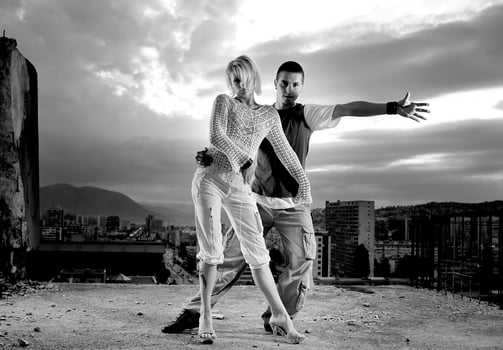romantic urban couple dancing on top of  bulding photo