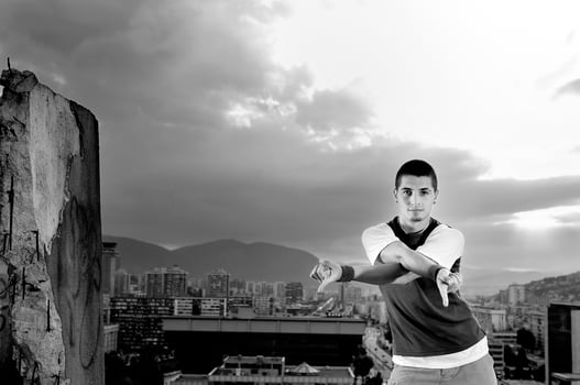 young man jumping in air outdoor at night ready to party photo