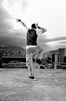 young man jumping in air outdoor at night ready to party photo