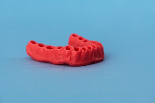 human gums without teeth model medical implant isolated on blue background. Healthy teeth, dental care and orthodontic concept. photo