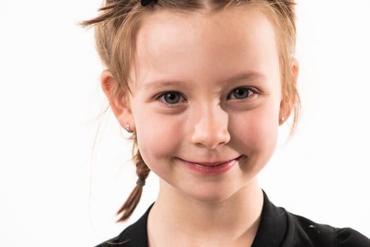 Portrait of a little girl on a white background with healthy, developing teeth photo