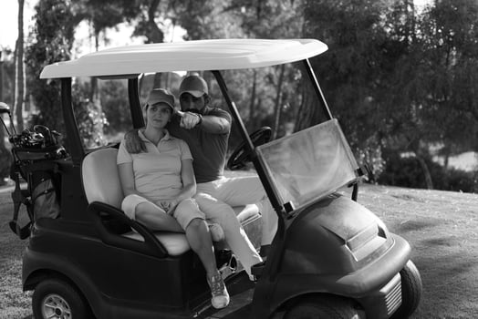 couple in buggy on golf course photo