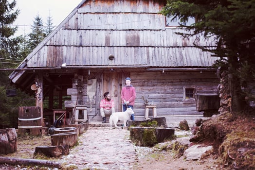 frineds together in front of old wooden house photo