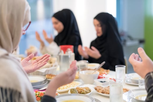 Muslim family making iftar dua to break fasting during Ramadan. photo