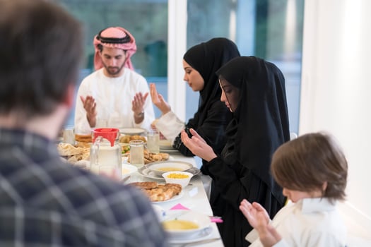 Muslim family making iftar dua to break fasting during Ramadan. photo