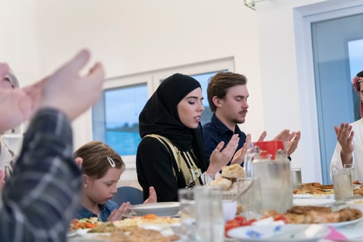 Muslim family making iftar dua to break fasting during Ramadan. photo