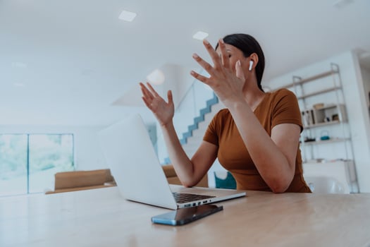 Woman sitting in living room using laptop look at cam talk by video call with business friend relatives, head shot. Job interview answering questions. photo