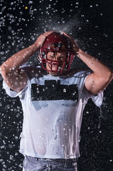 American Football Field Lonely Athlete Warrior Standing on a Field Holds his Helmet and Ready to Play. Player Preparing to Run, Attack and Score Touchdown. Rainy Night with Dramatic Fog, Blue Light photo