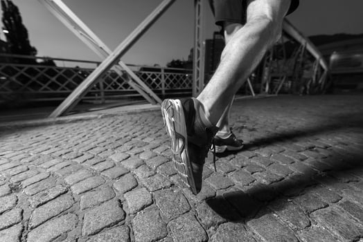 man jogging across the bridge in the city photo