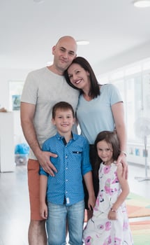 Portrait of a happy family. Photo of parents with children in a modern preschool classroom. Selective focus