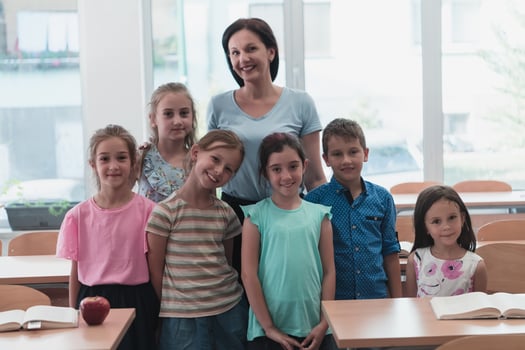 Portrait of children in a preschool institution with their teacher in a torn classroom. Selective focus photo