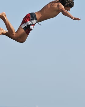 boy jump sea photo