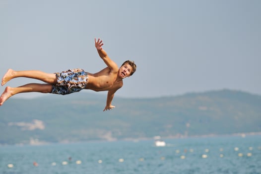 boy jump sea photo