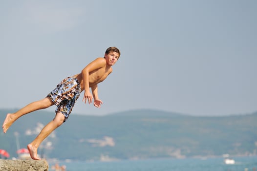 boy jump sea photo