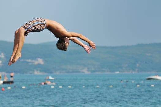 boy jump sea photo