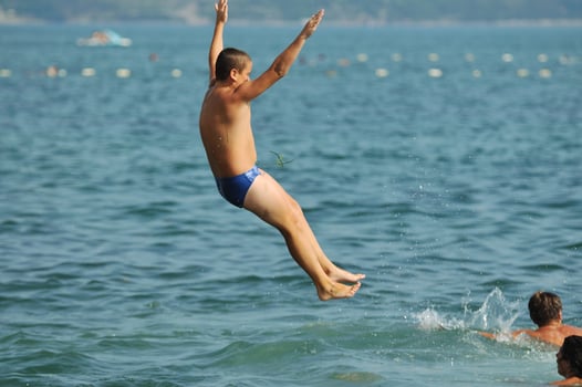 boy jump sea photo