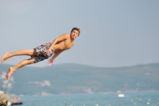 boy jump sea photo