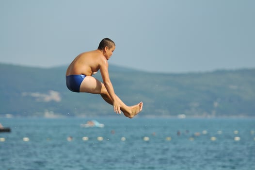 boy jump sea photo