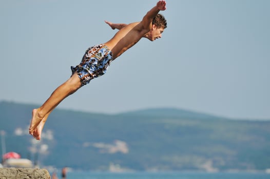 boy jump sea photo
