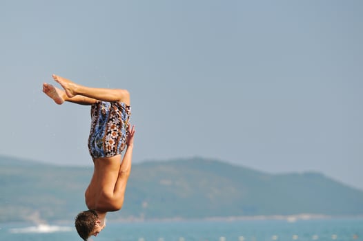 boy jump sea photo
