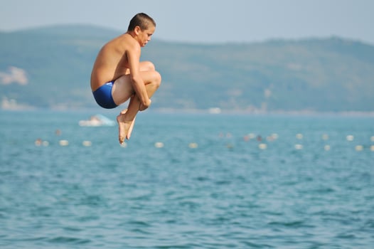 boy jump sea photo