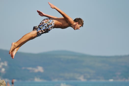 boy jump sea photo