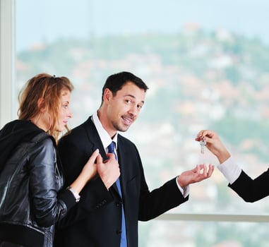 happy young couple buying new home with real estate agent photo
