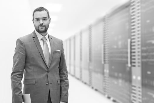 Young businessman in server room photo