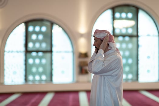 a Muslim begins to offer prayer by raising his hands in the air, a calm state in prayer photo