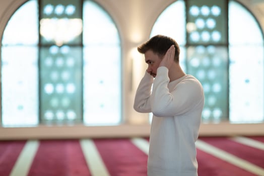 a Muslim begins to offer prayer by raising his hands in the air, a calm state in prayer photo
