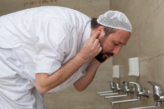 A Muslim takes ablution for prayer. Islamic religious rite photo