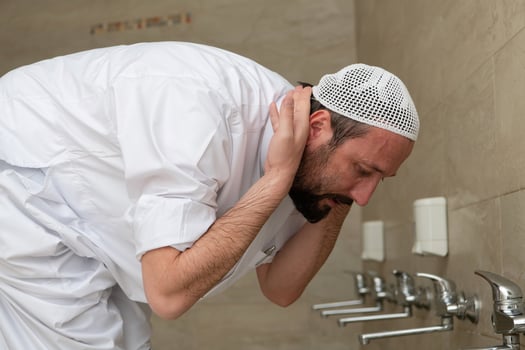 A Muslim takes ablution for prayer. Islamic religious rite photo