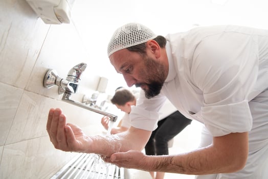 a group of Muslims take ablution for prayer. Islamic religious rite photo