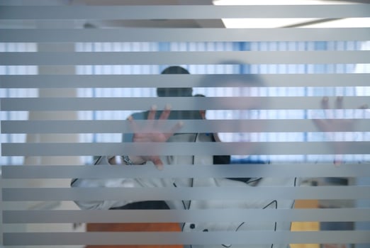 young businesswoman looking trought transparent wall photo